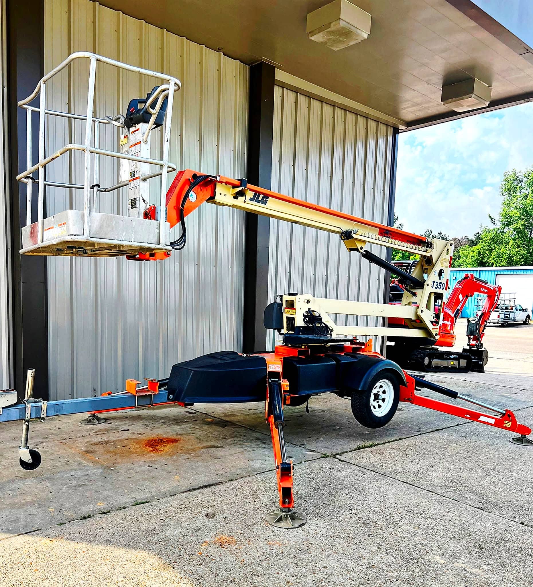JLG T350 boom lift set up with outriggers down and the platform raised