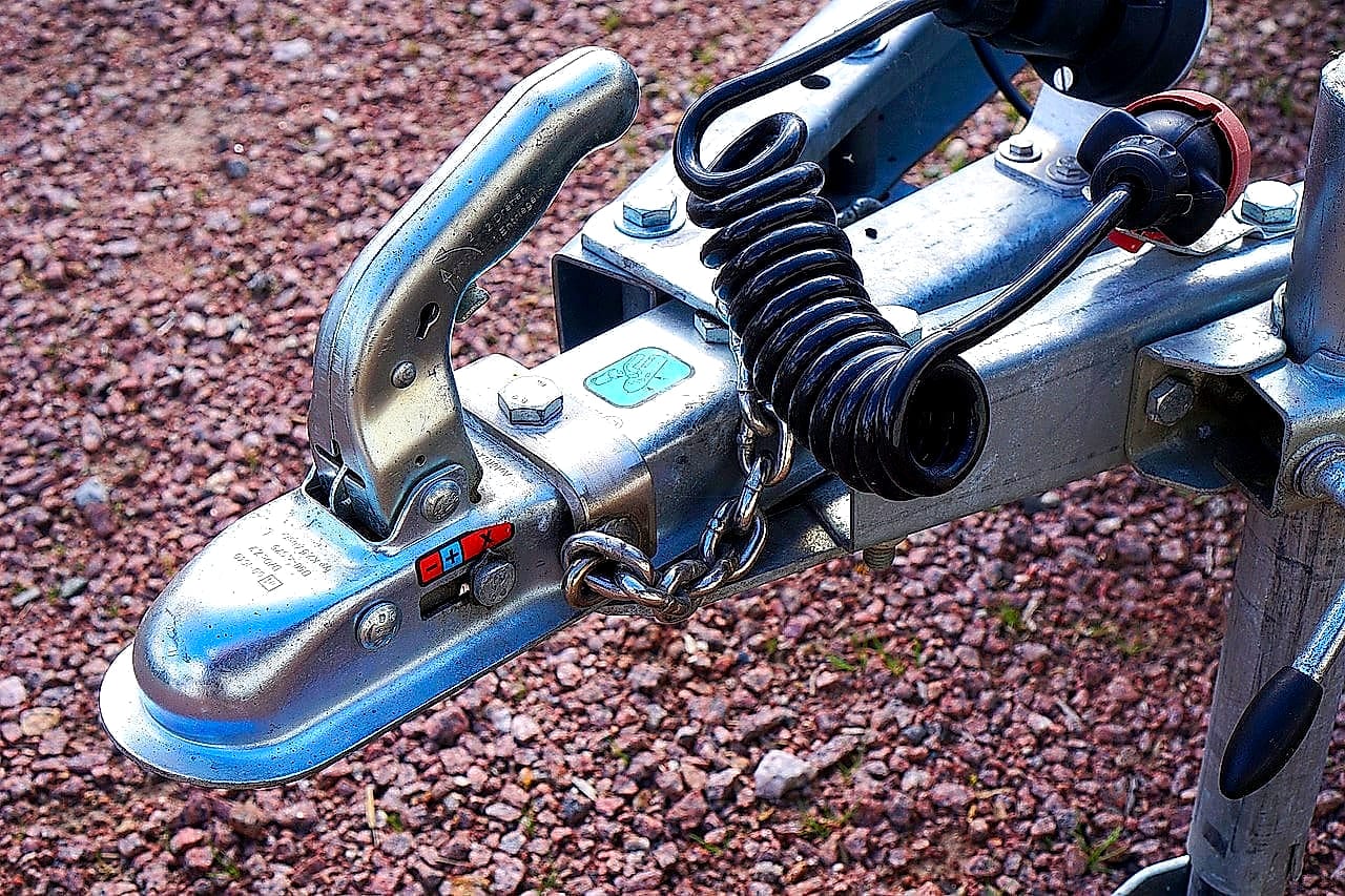 Trailer coupler, jack and safety chains on a utility trailer tongue