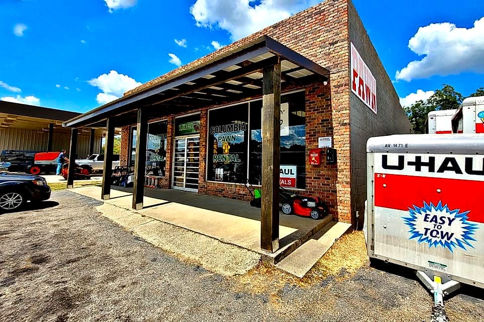 Columbia Pawn & Rental storefront with a U-Haul trailer out front