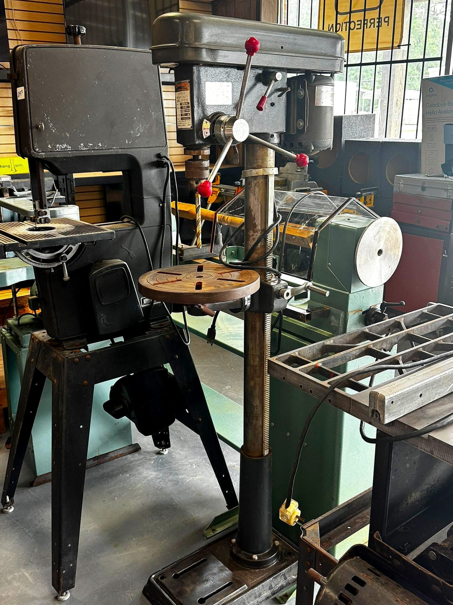 Drill press and shop tools on the floor at Columbia Pawn