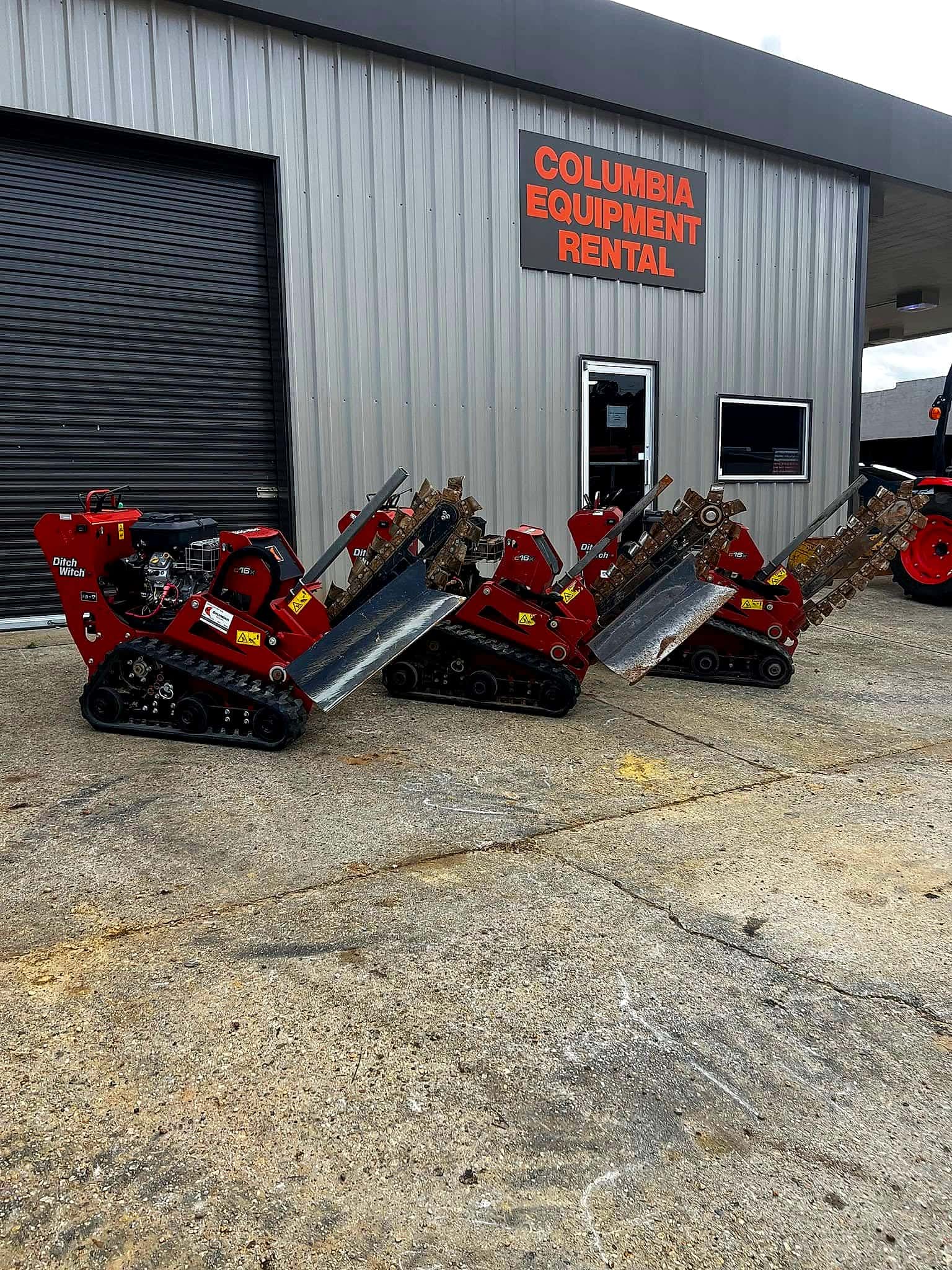 Ditch Witch trenchers lined up under the Columbia Equipment Rental sign
